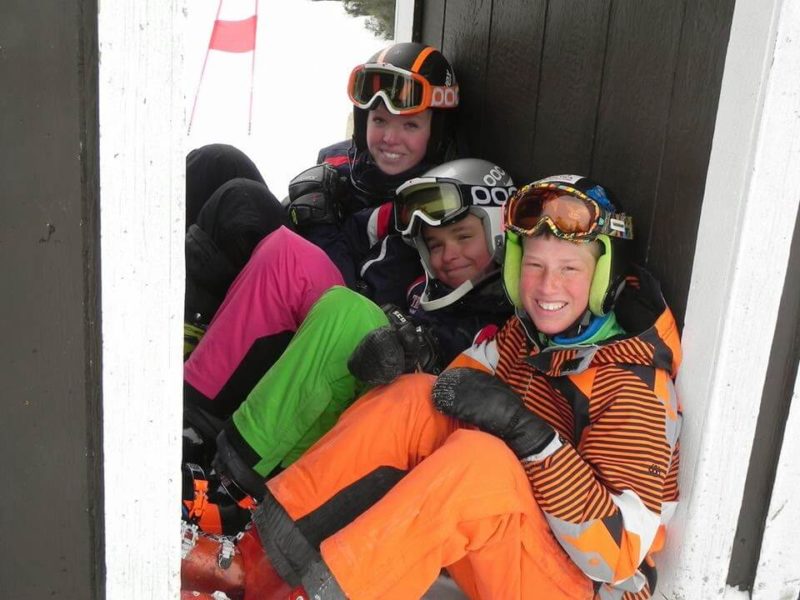 Three Skiers in Full Side Zip Pants sitting.