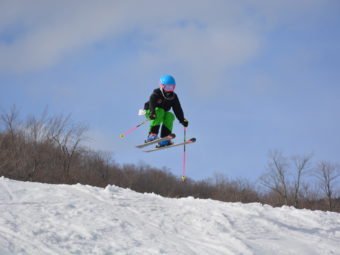 Chloe Avery of Smuggler's Notch Ski Racing Club in her Arctica Side Zip 2.0 pants jumping higher than the boys!