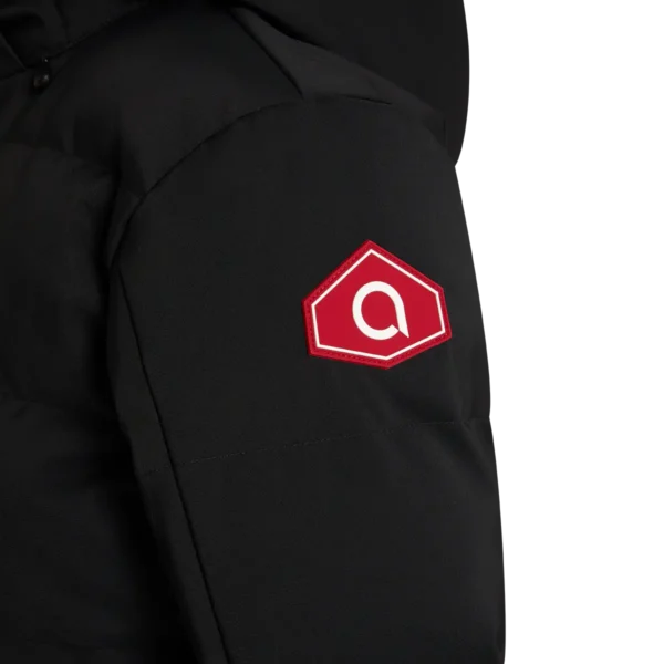 Close-up of the red hexagonal logo patch on the sleeve of the Arctica Men's 416 Classic Down Jacket in Black.