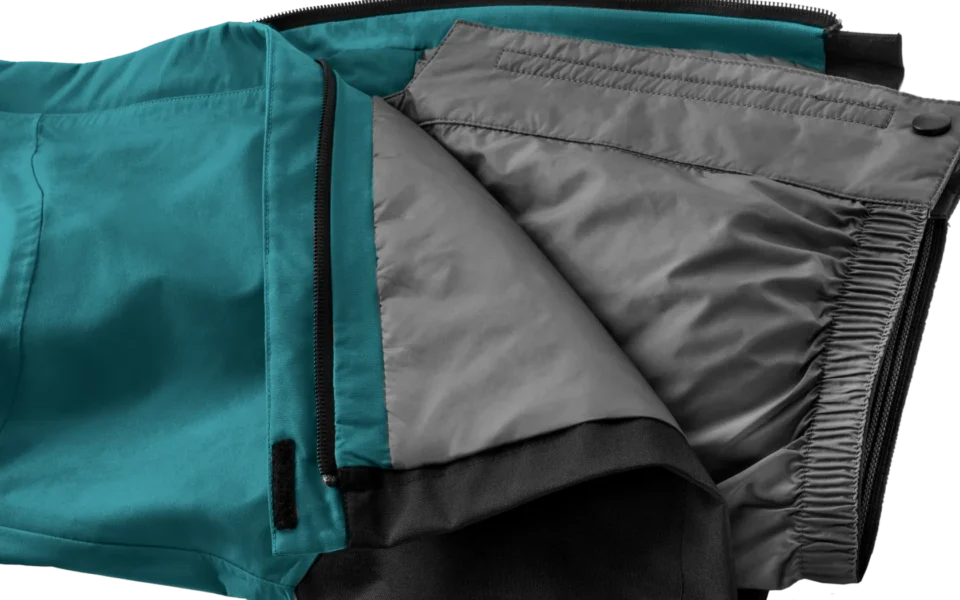 Close-up of the Arctica Side Zip Ski Pants 2.0 in Balsam opened to show the gray lining.