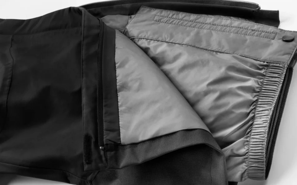 Close-up of the Arctica Side Zip Ski Pants 2.0 in Black opened to show the gray lining.