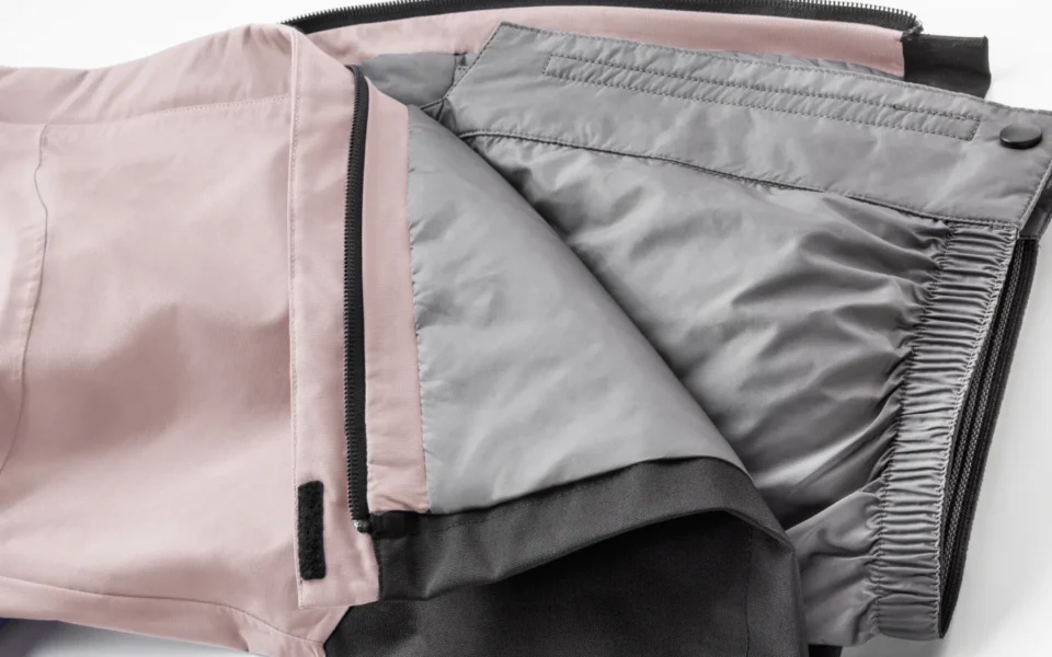 Close-up of the Arctica Side Zip Ski Pants 2.0 in Blush opened to show the gray lining.