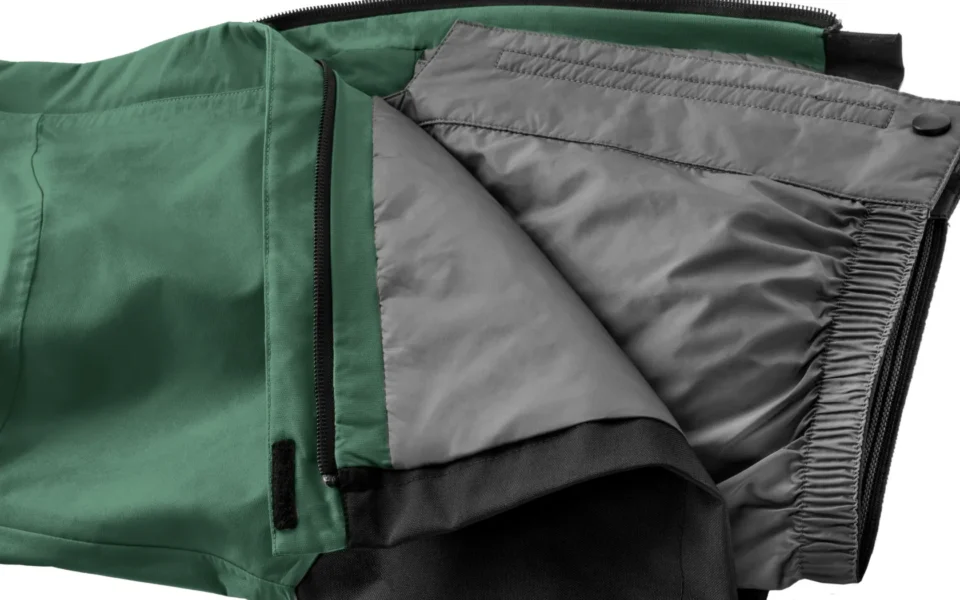 Close-up of the Arctica Side Zip Ski Pants 2.0 in Evergreen opened to show the gray lining.