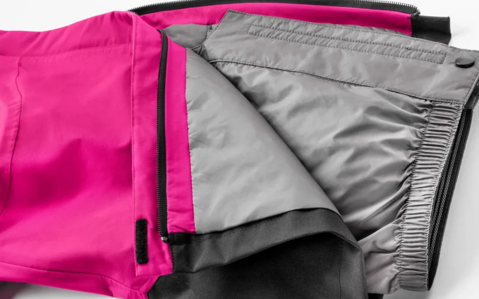 Close-up of the Arctica Side Zip Ski Pants 2.0 in Hot Pink opened to show the gray lining.