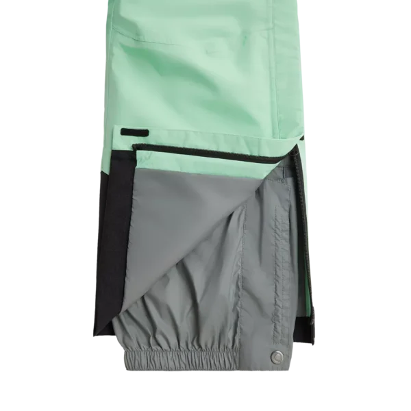 Close-up of the lower leg of the Arctica Adult Side Zip Pants 2.0 in Mint, opened to show the gray snow cuff.
