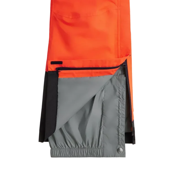 Close-up of the lower leg of the Arctica Adult Side Zip Pants 2.0 in Volcano, opened to show the gray snow cuff.