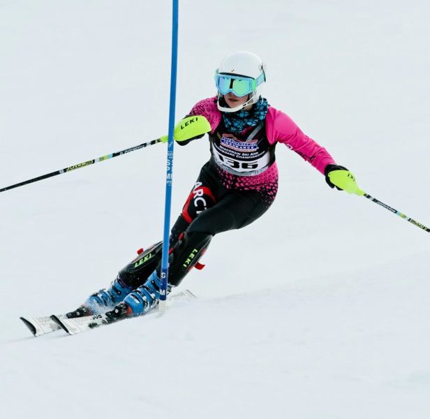Young, female ski racer ski racing at the Wisconsin Ski and Snowboard Championships in her Arctica GS Speed Suit.